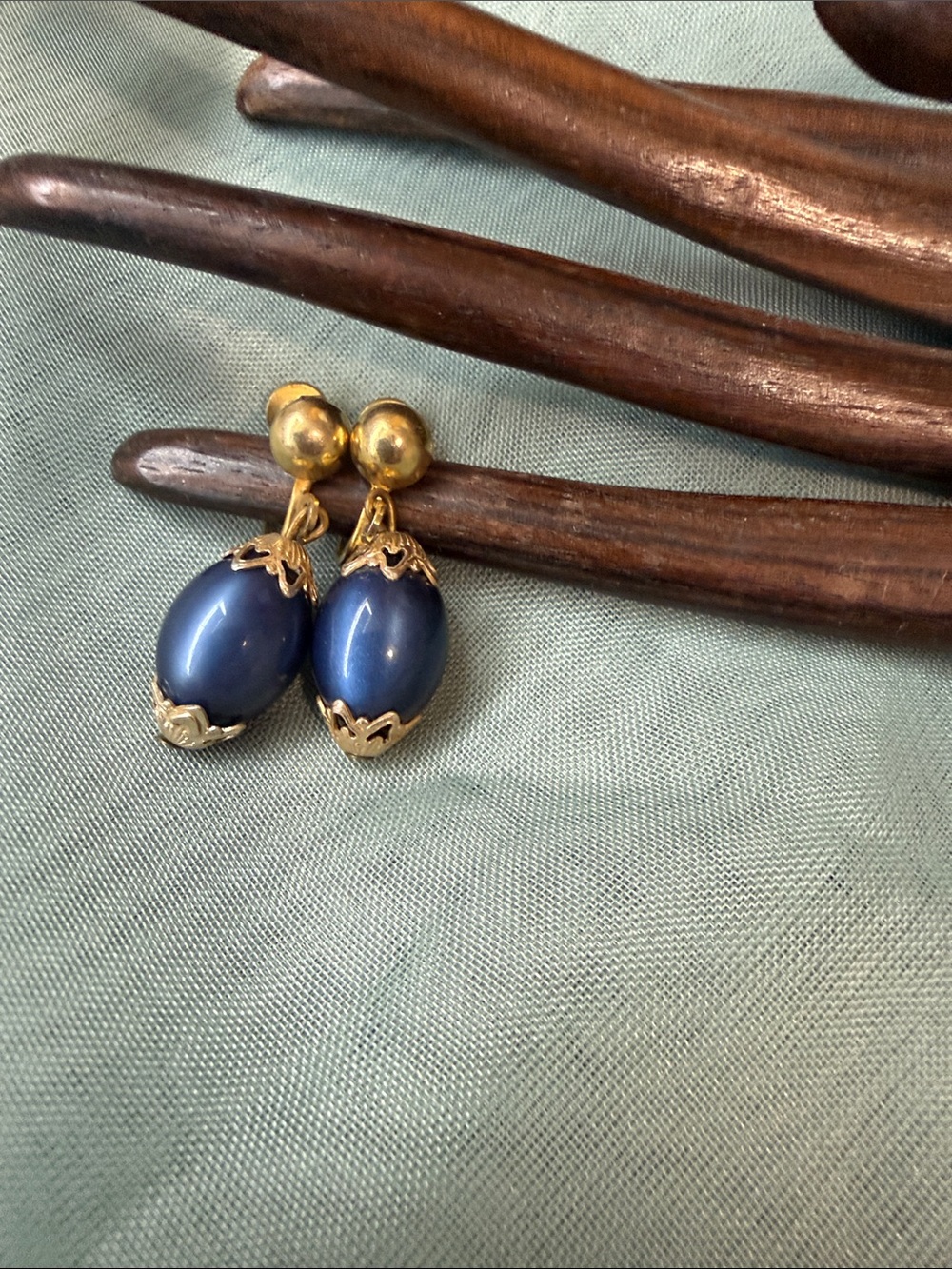 Vintage Art Deco style dangle clip-on earrings featuring dark blue glass stones
